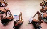 Aerial view photo of eight harp students practice together.