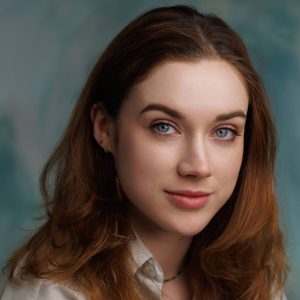 Cate is smiling at the camera.