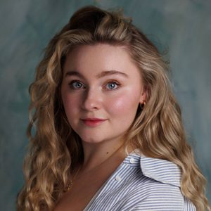 Lucy is looking at the camera.