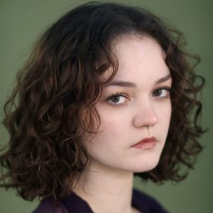 Martyna is looking at the camera.