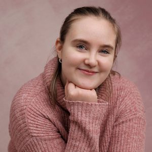 Selina is smiling at the camera.