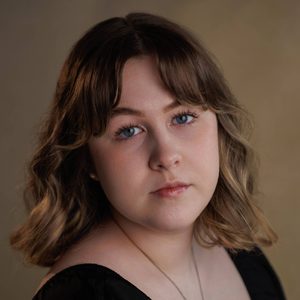 Tyler is looking at the camera.