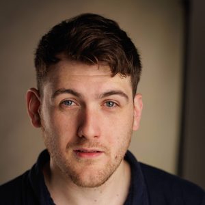 David is smiling at the camera.