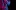 Close up of a clarinet be played, lit in purple and blue.