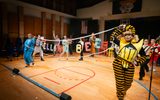A group of actors are performing on stage in a production of Spelling Bee.