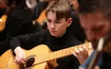 Juniors Student playing a Guitar