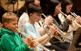 Photograph focusing on young brass players.