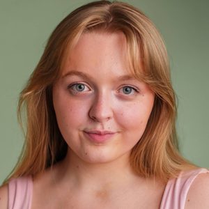 Grace is smiling at the camera.