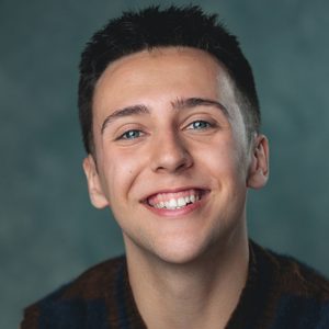 Jack is smiling at the camera.