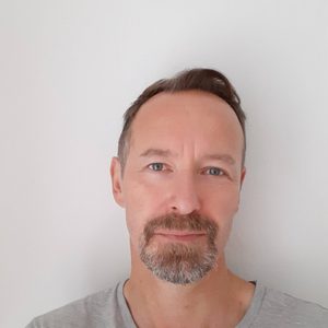 Lorenzo is looking at the camera. He is wearing a light coloured t-shirt.