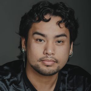 Matty is looking at the camera.