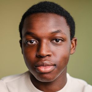 Nathan is looking at the camera.