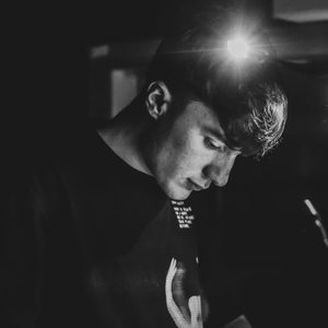 Saul is looking down. The image is black and white.