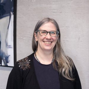 Headshot of Una McGloane - she is smiling at the camera
