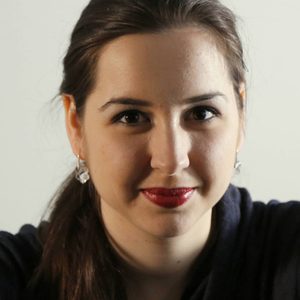 Silviya is smiling at the camera.