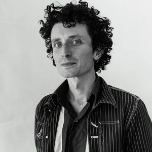 Laurie is smiling at the camera. The image is black and white.