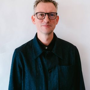 Josh is looking at the camera.