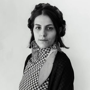 Maria is looking at the camera. The image is black and white.