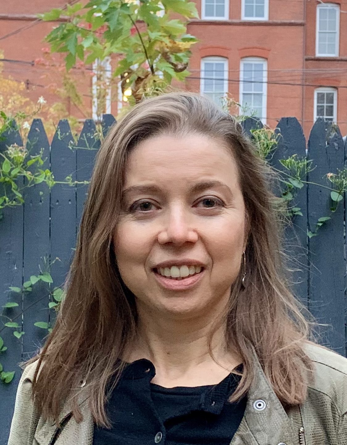 Jane Alden is looking at the camera.