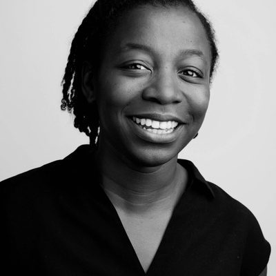 Mercy is smiling at the camera. The image is black & white.