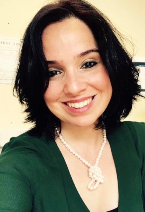 Farah is smiling at the camera.