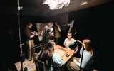 Film students on set filming a group of actors