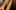 A close up image of a hand strumming a guitae