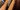 A close up image of a hand strumming a guitae